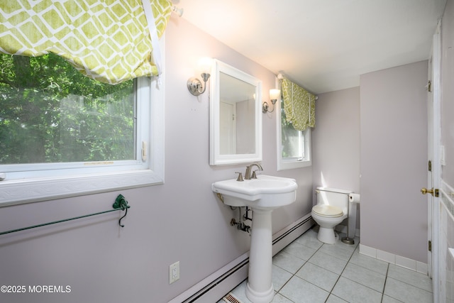 bathroom featuring tile patterned flooring, a baseboard radiator, toilet, and plenty of natural light