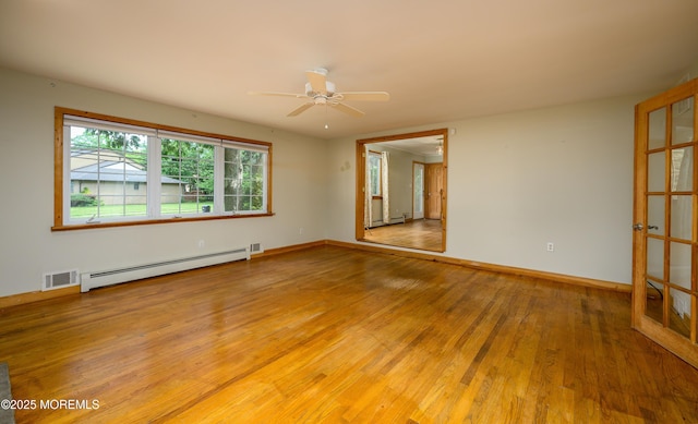 unfurnished room featuring hardwood / wood-style flooring, ceiling fan, and baseboard heating