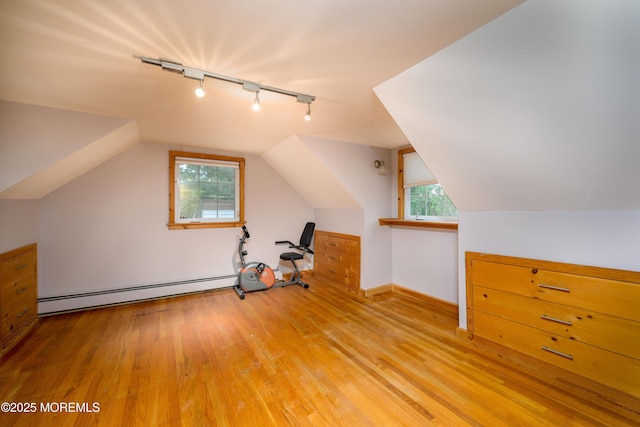 bonus room with light hardwood / wood-style flooring, a baseboard radiator, and vaulted ceiling