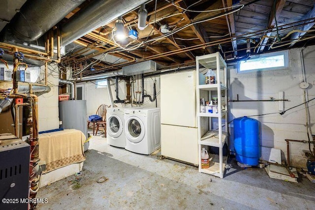 basement with gas water heater and separate washer and dryer