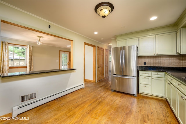 kitchen featuring a baseboard radiator, light hardwood / wood-style flooring, backsplash, stainless steel fridge, and ornamental molding