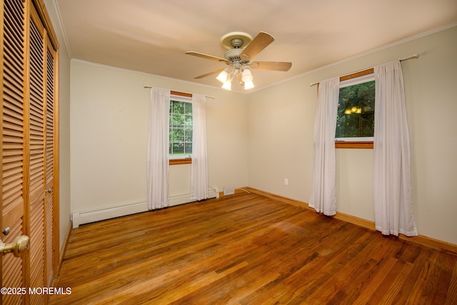 unfurnished bedroom with ceiling fan, wood-type flooring, and ornamental molding