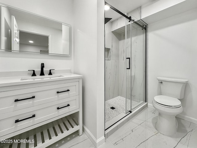 bathroom with a shower with door, vanity, and toilet