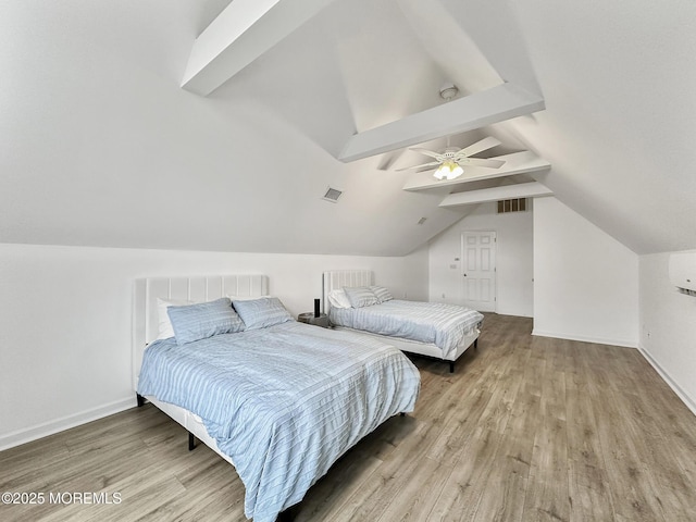 bedroom with ceiling fan, lofted ceiling, and light wood-type flooring