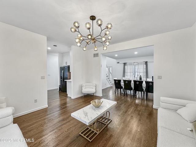 living room featuring dark hardwood / wood-style flooring and a notable chandelier