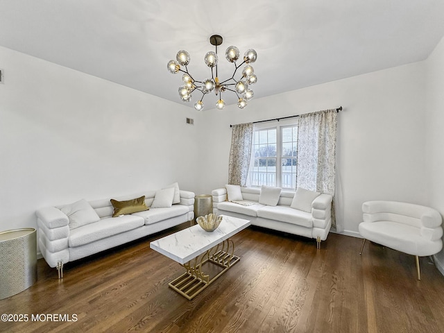 living room featuring dark hardwood / wood-style floors and an inviting chandelier