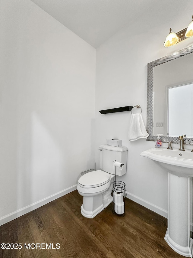 bathroom featuring hardwood / wood-style floors, toilet, and sink