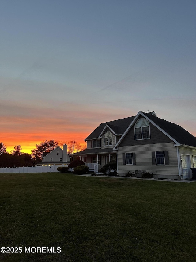 view of front of house with a garage and a yard