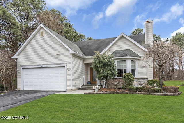 view of front of property featuring a front lawn and a garage