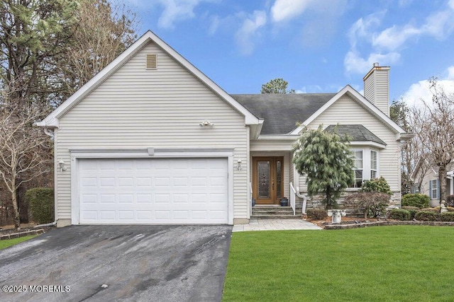 view of front of property with a front lawn and a garage