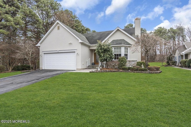 view of front of home featuring a front yard and a garage