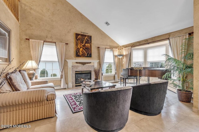 living room featuring a premium fireplace, light tile patterned flooring, and high vaulted ceiling