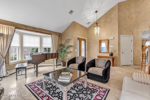 living room with high vaulted ceiling, a chandelier, and french doors