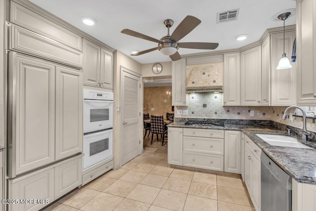 kitchen with pendant lighting, stainless steel appliances, light tile patterned floors, ceiling fan, and sink