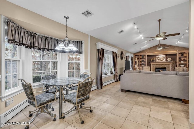 dining area featuring baseboard heating, vaulted ceiling, ceiling fan with notable chandelier, and light tile patterned floors