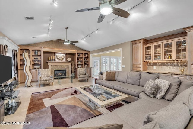 living room featuring a fireplace and vaulted ceiling