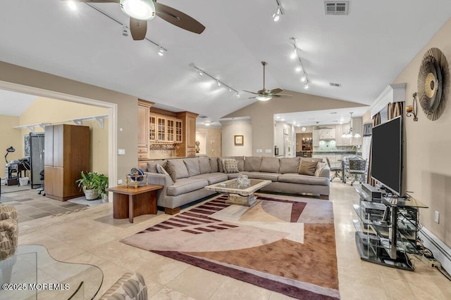 tiled living room with baseboard heating, ceiling fan, and vaulted ceiling