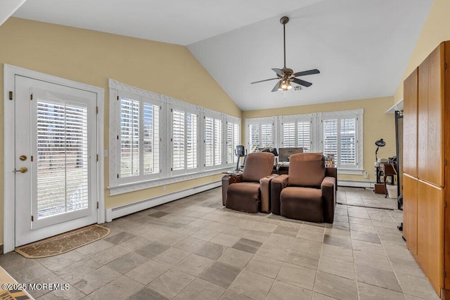 sunroom with ceiling fan, baseboard heating, and vaulted ceiling