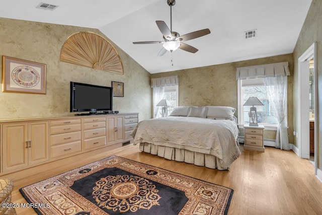 bedroom with lofted ceiling, ceiling fan, a baseboard radiator, and light hardwood / wood-style floors