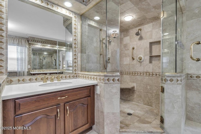 bathroom featuring ornamental molding, vanity, and a shower with shower door