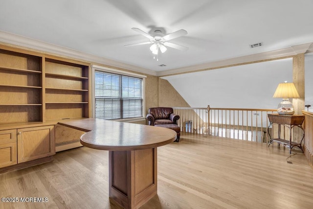 office space with lofted ceiling, baseboard heating, light wood-type flooring, crown molding, and ceiling fan