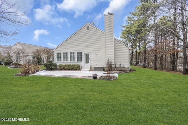 rear view of property featuring a yard and a patio area