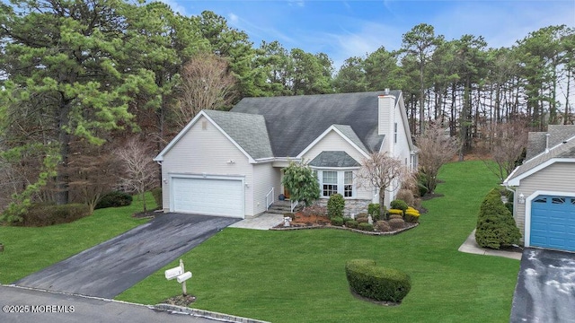 view of front of house featuring a front yard and a garage