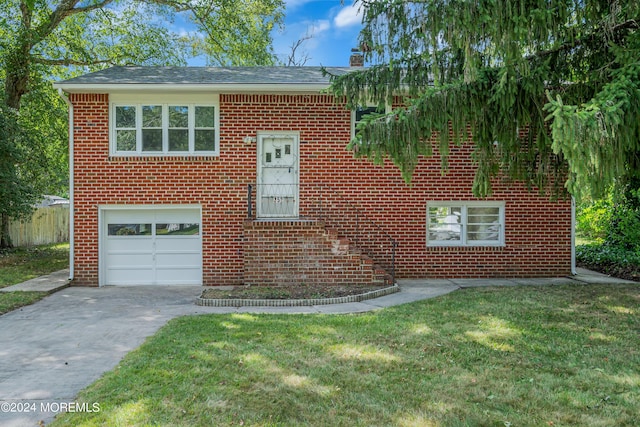 view of front of home featuring a garage and a front lawn