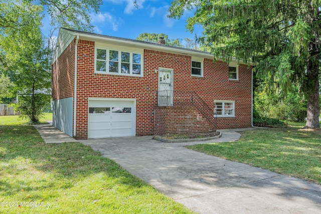 split foyer home with a front yard and a garage