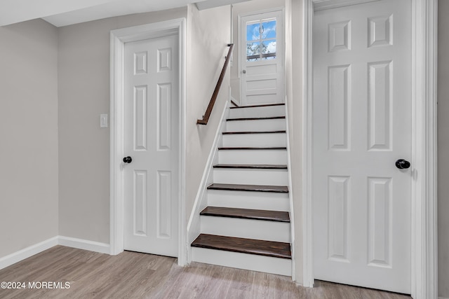 staircase with wood-type flooring