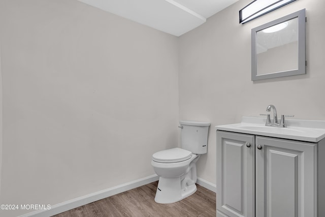 bathroom featuring hardwood / wood-style floors, vanity, and toilet