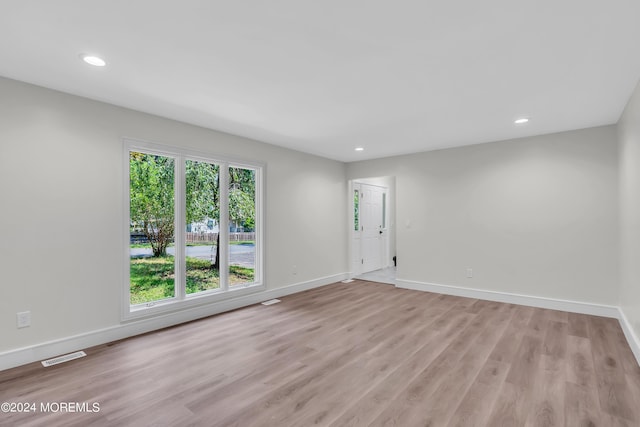 unfurnished room with light wood-type flooring