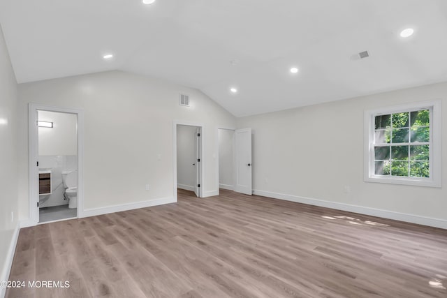 interior space featuring light hardwood / wood-style floors and lofted ceiling