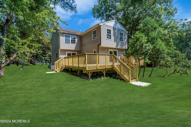 back of house with a yard and a wooden deck