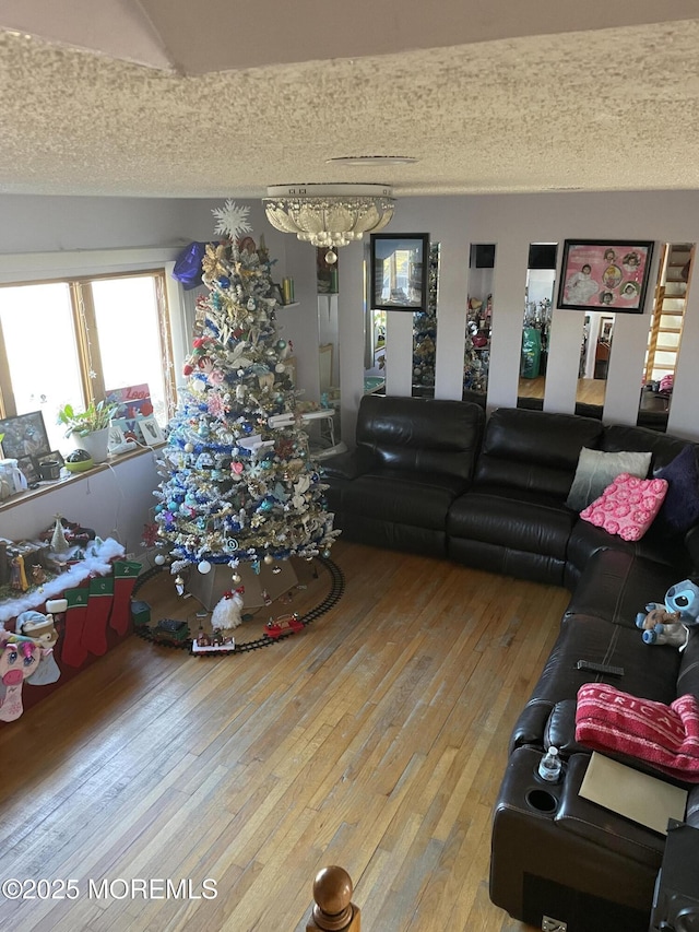 living room with hardwood / wood-style flooring and a chandelier