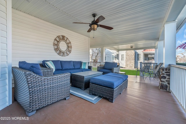 deck with ceiling fan and an outdoor living space