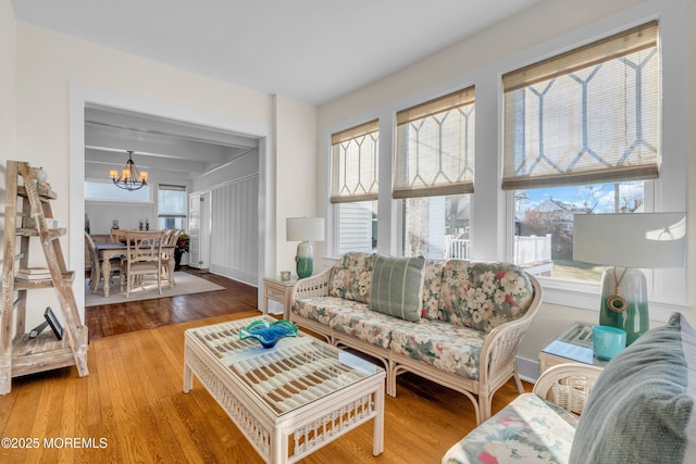 living room featuring wood-type flooring and a chandelier