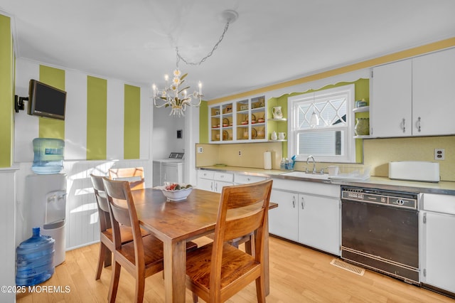 kitchen with white cabinets, dishwasher, sink, and washer and clothes dryer