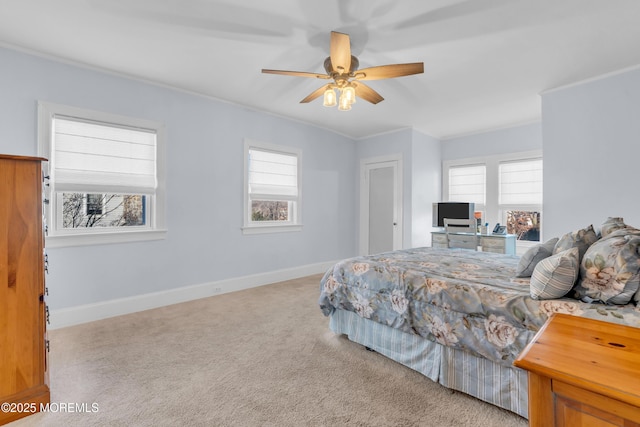 carpeted bedroom with ceiling fan and ornamental molding