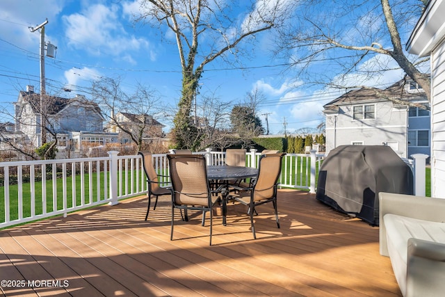 wooden terrace with grilling area and a yard