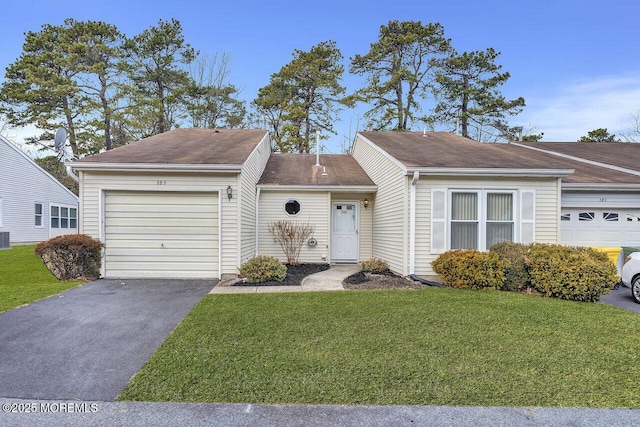 view of front of home with a front lawn and a garage