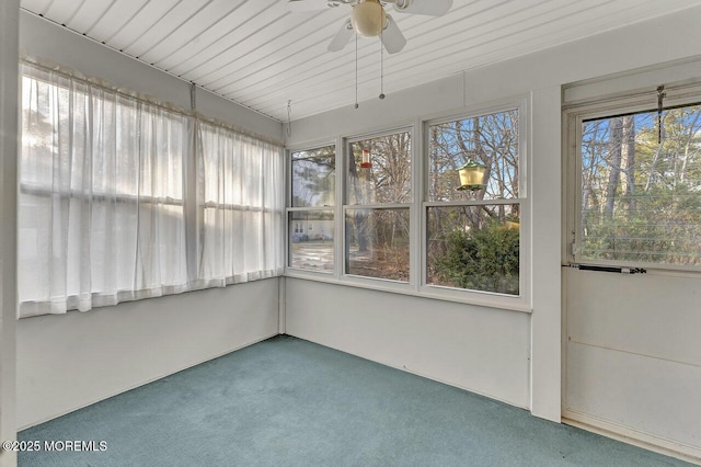 unfurnished sunroom featuring ceiling fan