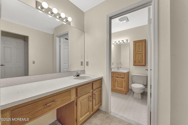 bathroom with tile patterned floors, vanity, and toilet