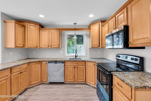 kitchen featuring light stone countertops, stainless steel appliances, light hardwood / wood-style floors, and sink