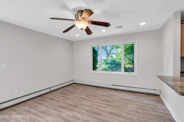 unfurnished room featuring ceiling fan, a baseboard radiator, and light wood-type flooring