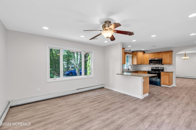 kitchen featuring a baseboard heating unit, sink, decorative light fixtures, kitchen peninsula, and stainless steel appliances