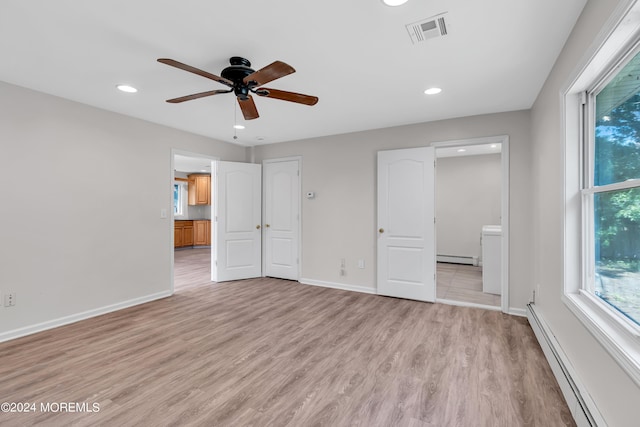 unfurnished bedroom with connected bathroom, light hardwood / wood-style flooring, baseboard heating, and ceiling fan