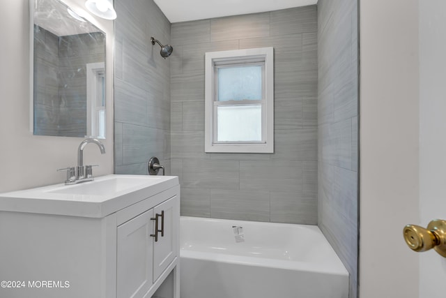 bathroom with vanity and tiled shower / bath combo