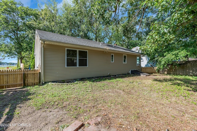 rear view of property with a lawn