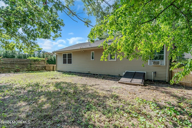 rear view of house featuring a lawn